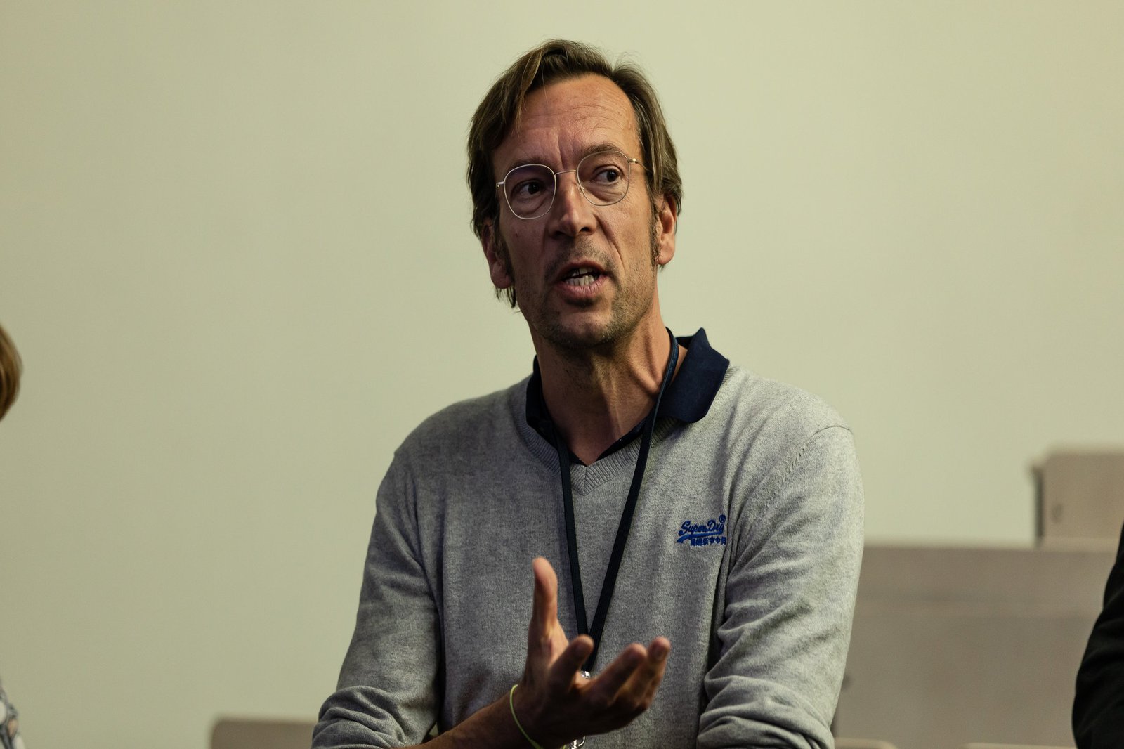 Ein Mann spricht angeregt zu seinen Zuhörer:innen.