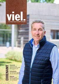 viel.33 Titelblatt Ehrenamt, eine Personen steht auf einer Grünfläche vor einem Hochschulgebäude