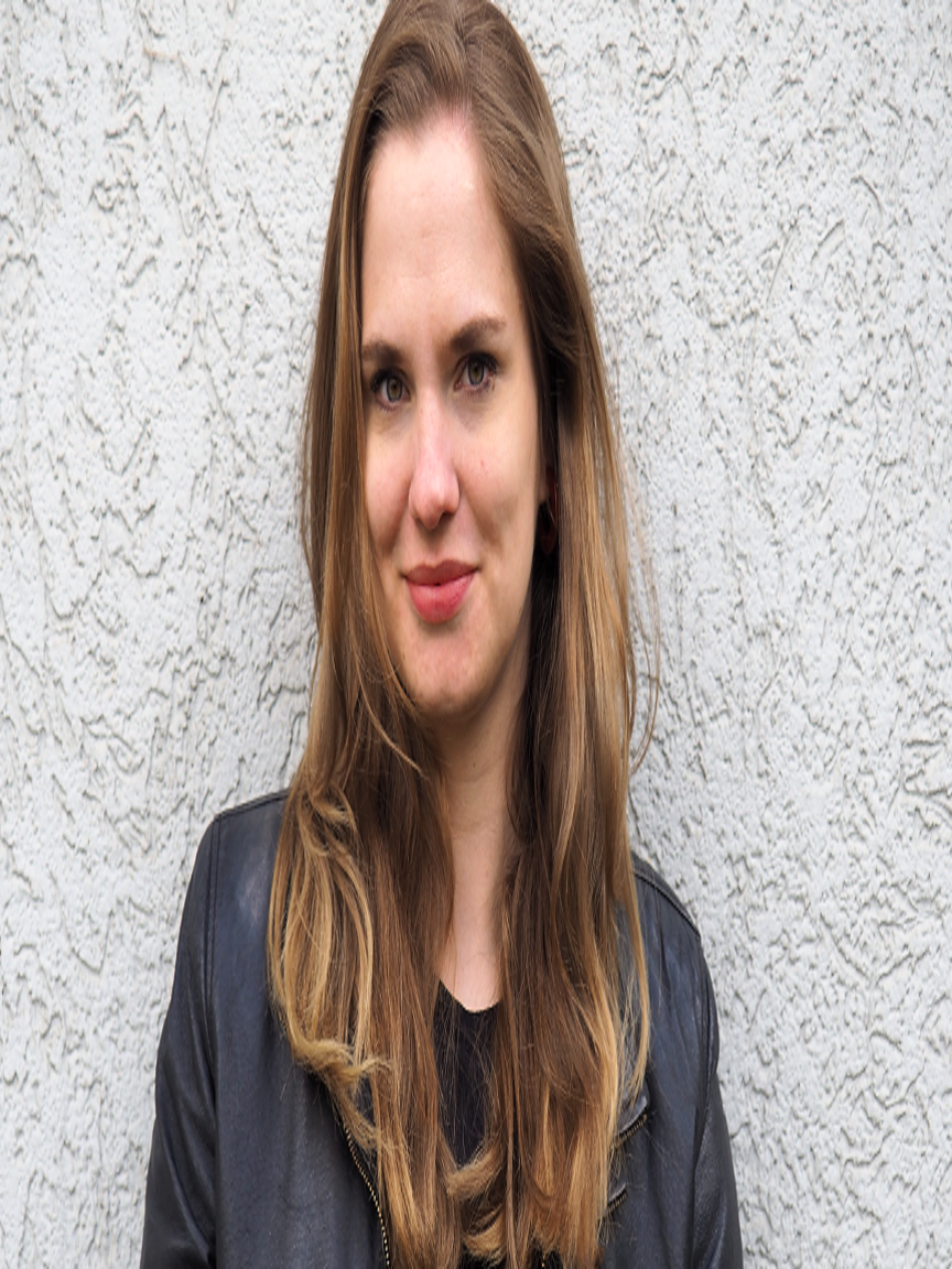 a woman standing in front of a wall