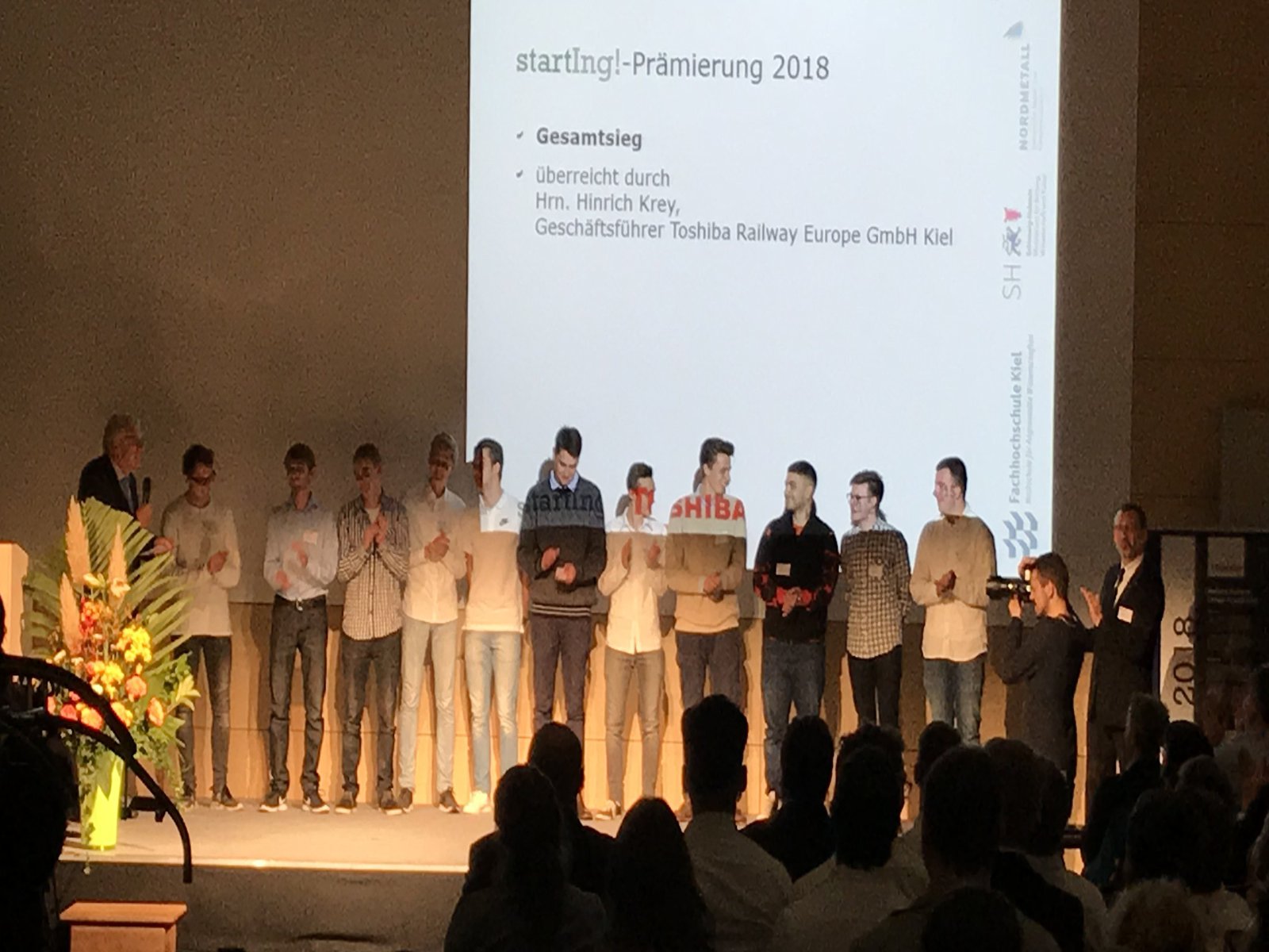 Eine Gruppe Studierender steht auf der Bühne.