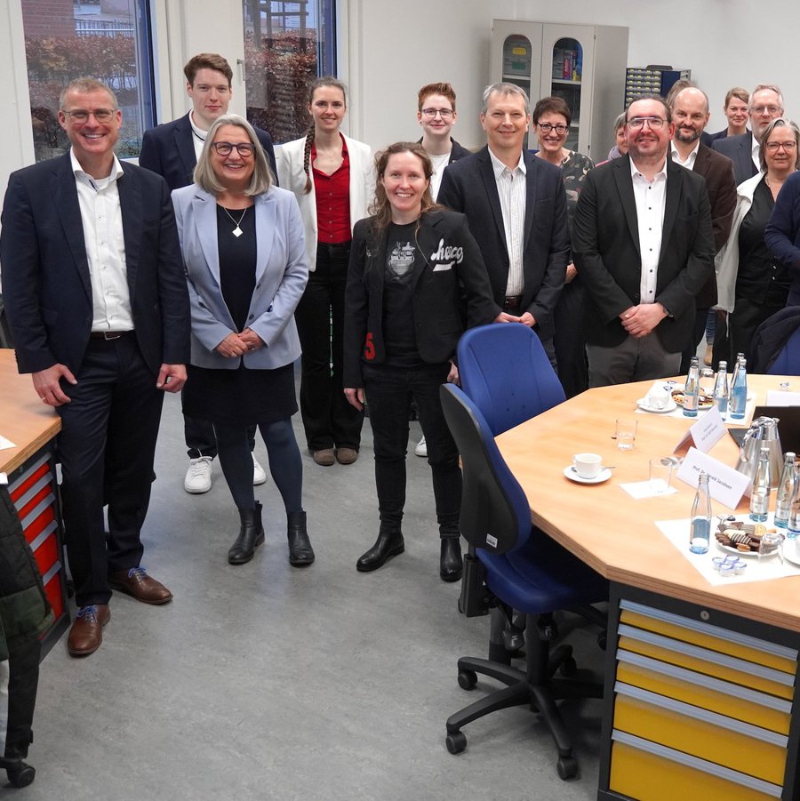 (Vorne links in der ersten Reihe:) FH-Kiel-Präsident Prof. Dr. Björn Christensen, Staatssekretärin Dr. Dorit Stenke, Sabrina Schönfeld, Programmleiterin Jugendcampus an der FH Kiel, Prof. Dr. Harald Jacobsen und Prof. Dr. Hanno Kallies sowie Vertreter der Toni-Jensen-Gemeinschaftsschule und Mitarbeitende der FH Kiel.