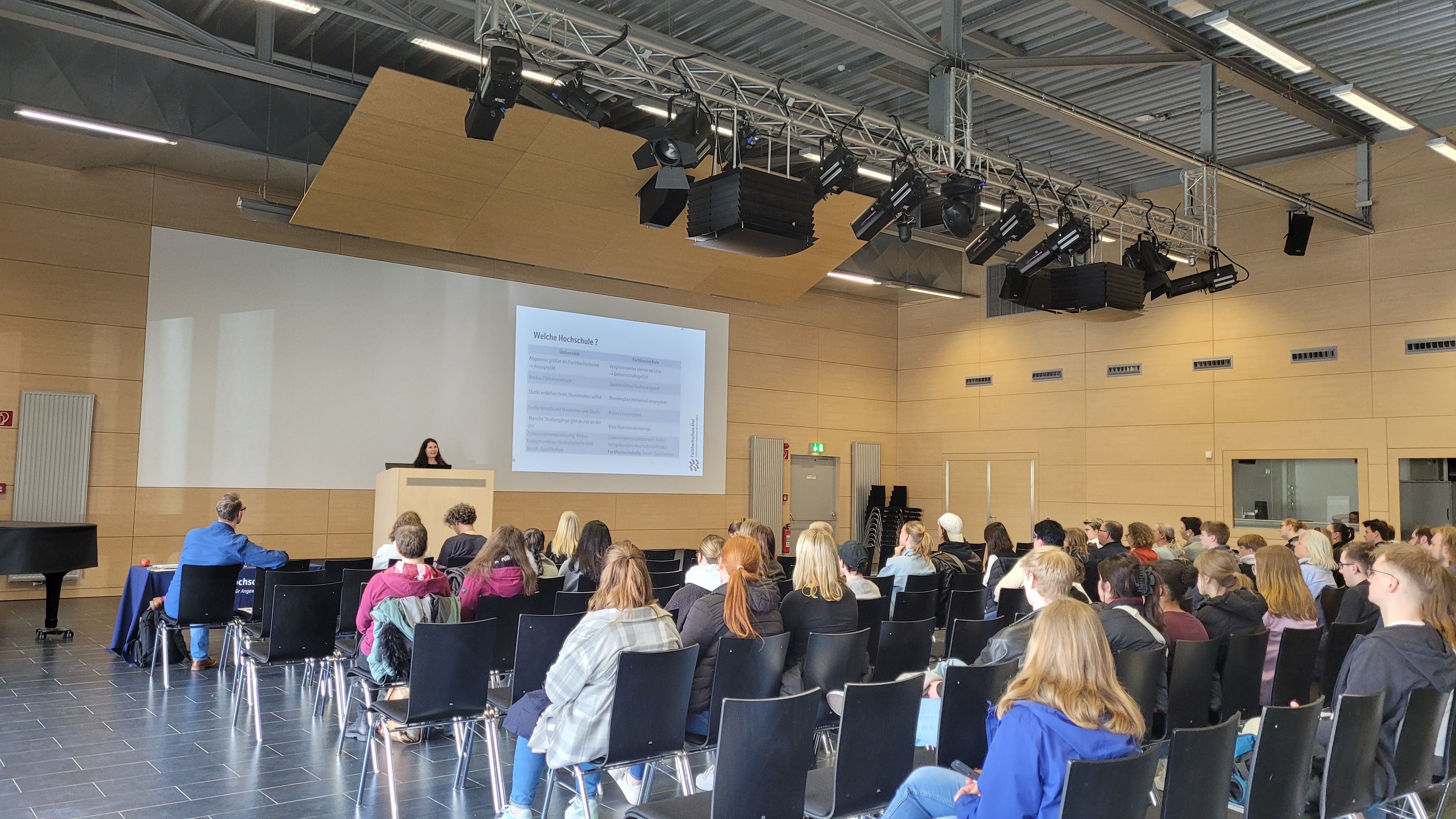 Blick in den Audimax der FH Kiel auf Stuhlreihen mit Besucherinnen und Besuchern